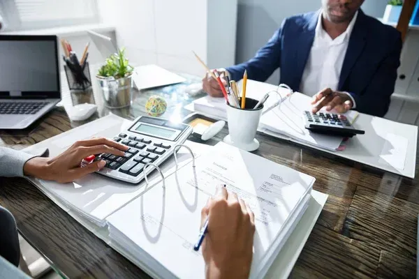 A team collaborating over automated bookkeeping reports to optimize financial workflows.