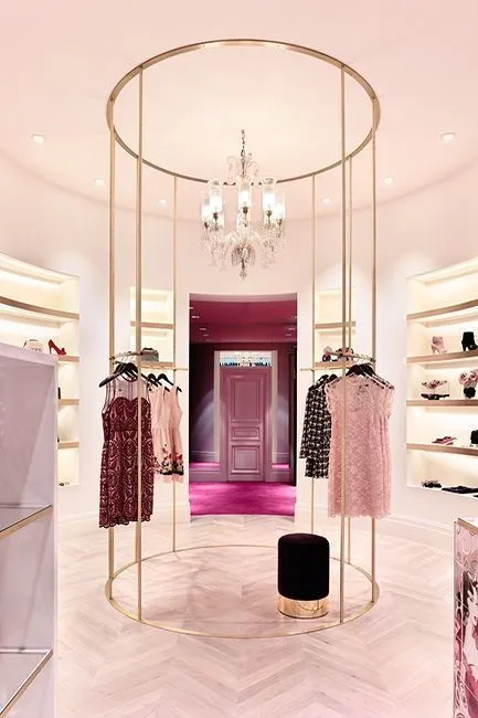A modern retail space featuring curved display areas and a refined, high-fashion setting.